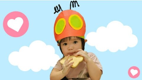 kid with a costume eating a cookie